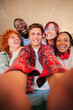 © Jose Calsina - Joyful group of multiracial friends enjoying a fun selfie moment together, showcasing their happiness and camaraderie while capturing a memorable experience in their lives as students and classmates