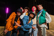 © Jose Calsina - Group of Young Adult Friends Posing Cheerfully in Urban Street wear Fashion with Energetic Expressions. HipHop Dancers Posing for a Fun and Vibrant Social Media Photo Shoot at Night Lifestyle