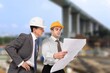 © BillionPhotos.com - Industrial engineers workers in hard hats talk of new project.