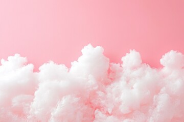 Wall Mural - White cotton candy like clouds on a pastel pink background