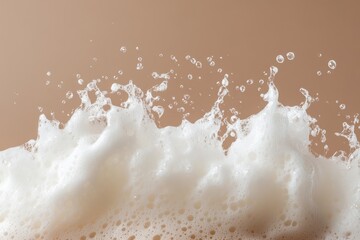 Wall Mural - Frothy white foam erupts with scattered droplets against a tan background