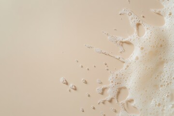 Wall Mural - Beige liquid spreading and bubbling across a surface top view