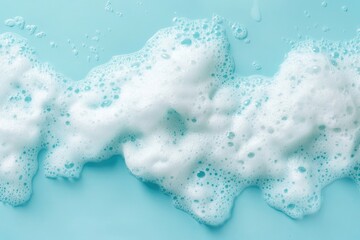 Canvas Print - White foamy bubbles resting on a pastel blue surface