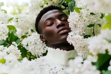 Wall Mural - Man is lying in a field of white flowers