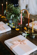 © tisaeff - Elegant dinner setting with gift boxes and candlelight at a stylish table