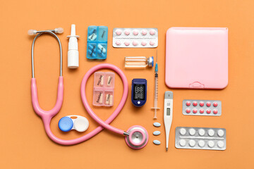 Wall Mural - Composition with pulse oximeter, stethoscope, thermometer and medicines on orange background