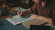 © Postmodern Studio - A woman is drawing a map on a table