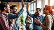 © redtiger9 - Indian business team celebrating a milestone with a high five in a dynamic and energetic office
