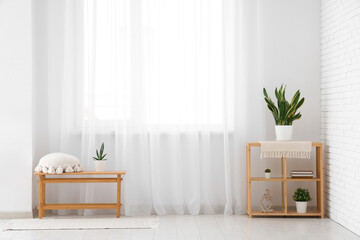 Wall Mural - Bench with shelf unit and plants near light curtain in room