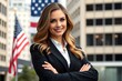 © prarthana - A beautiful businesswoman in front of a building and an American flag.