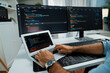 © InfiniteFlow - Cropped typing hands photo in IT developer working software development coding on laptop with creating application program update version website on two computer code screen at modern office. Surmise.