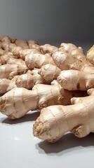 Wall Mural - Fresh ginger roots clustered on white background with natural light