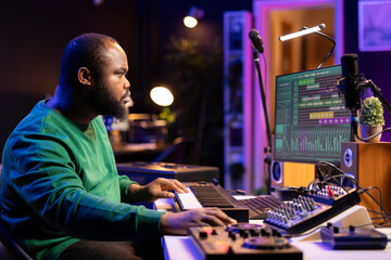 Leinwandbilder - Music engineer producing a song by mixing and mastering tunes on audio console, playing piano notes on synthesizer to record sounds on pc software. Producer creating soundtracks with midi controller.