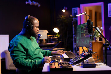 Leinwandbilder - Music composer adding tracks as sound effects for a new song, recording sounds on electronic piano synthesizer. Songwriter audio technician editing and mixing tunes on software.