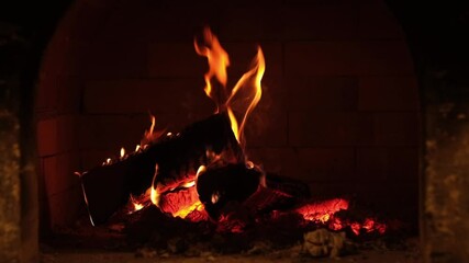 Poster - Cozy fireplace burning logs in a brick hearth during the evening hours creating