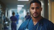 © Daiki - A young mixed race man in medical scrubs stands confidently, showcasing professionalism in a hospital setting. He embodies care and dedication to healthcare.