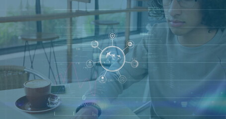Wall Mural - image of network of connections with icons over data processing and biracial man using laptop