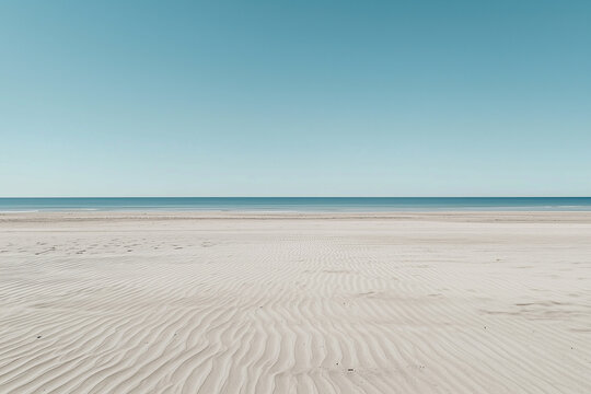wide camera angle captures deserted sand beach under clear blue sky