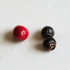 Wall Mural - Close-up of red and black peppercorns on a light background