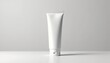 © Elena - Blank white cosmetics tube on neutral surface with soft lighting