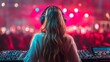 © Joachim - DJ performs at a vibrant music festival with colorful lights and an excited crowd