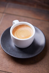 Wall Mural - Cup of coffee on wooden background. Soft focus. Copy space