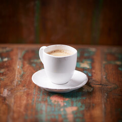 Wall Mural - Cup of coffee on wooden background. Soft focus. Copy space