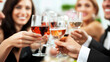 © Mirjana - Group of friends celebrating and toasting with glasses of wine at an elegant gathering in a festive setting