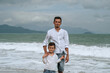 © alexkoral - happy father dad with a child boy son on the beach by the sea on a summer vacation