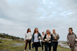 © Johnér - Group of happy female friends walking on hill while holding yoga mats