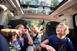 © Johnér - Happy brothers and sister sitting in car while looking at sun roof during road trip