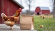 © Y_Malashkevych - Chickens stand next to a plain mockup of a food bag on a farm. A blurred red barn and greenery create a rustic outdoor setting highlighting the farm life and the importance of nutritious feed