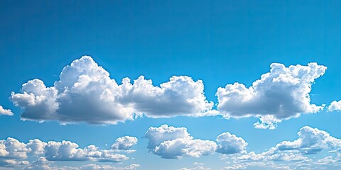 Poster - Fluffy white clouds scattered across a vibrant blue sky creating a serene daytime landscape with soft shadows and brightness.