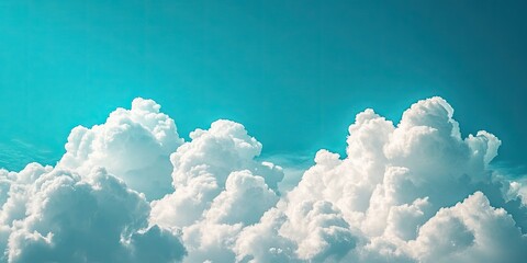 Poster - Majestic fluffy white clouds clustered against a serene turquoise sky, creating a tranquil daytime atmosphere with soft light and depth.