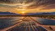 © jirapong - Vast Desert Solar Farm Under Dramatic Sky at Sunset with Rows of Panels Reflecting Sunlight in Golden Hue