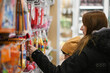 © juraj - Woman and child carefully selecting items in a stationery store, enjoying shopping experience together