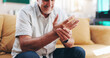 © peopleimages.com - Senior man, hand pain and arthritis in home, orthopedic joint inflammation and check wrist damage. Muscle, carpal tunnel and elderly person with injury accident, rheumatoid and poor circulation