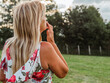 © Heart in pictures - Woman enjoying the serene landscape while contemplating life in a lush green field