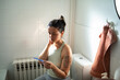 © Marko Geber - Woman looking at a pregnancy test in the bathroom