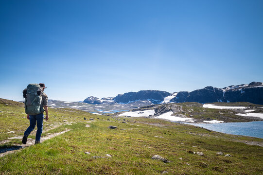 Man with a backpack hiking in a mountain area