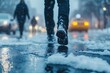 © Ardhana - A person walking on a snowy and wet city street
