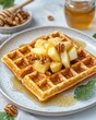 © Sarinya - Delicious waffle topped with caramelized apples and walnuts drizzled with honey in bright studio light