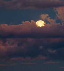 Wall Mural - moon rising between bright clouds