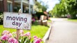 © Darunee - Moving Day Nostalgia: Well-Worn Sign Outside House with Packed Boxes in Driveway
