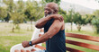© KayExam/peopleimages.com - Black man, shoulder pain and fitness with injury in nature for workout accident or ache on park bench. Mature, male person or sore arm with muscle tension or joint inflammation for physical strain