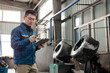 © zhu difeng - Middle-aged East Asian male blue-collar workers are using tablets in the factory