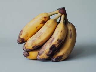 Ripe yellow bananas with brown spots.