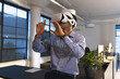 © Wavebreak Media - Businessman using VR headset in modern office, exploring virtual environment