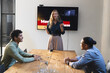 © Wavebreak Media - Presenting in meeting room, businesswoman engaging diverse colleagues in discussion, at office