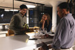 © Wavebreak Media - Diverse colleagues enjoying wine tasting at modern office bar during evening gathering